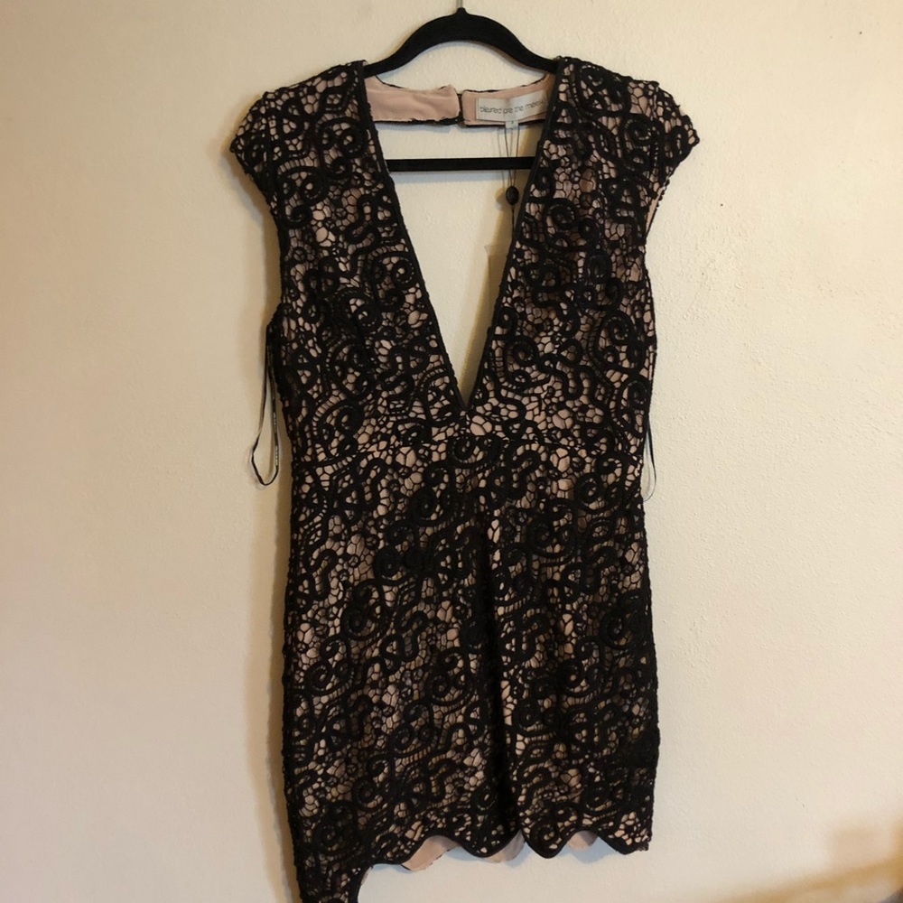 Sleeveless, open back, black lace dress